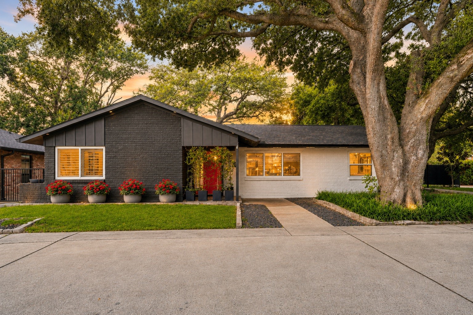 2302 Chimney Rock Road Houston, TX 77056 - Photo 27 of 28 Beautiful curb appeal with 4 amazing live oak trees, circular driveway, recent exterior paint, replaced exterior siding (2024), new roof (2024), double-pane energy efficient windows, Soffit accent lighting around the home, exterior flood lighting, full sprinkler system, complete gutter system, recent front door, and a gated driveway that leads to a motor court with 4 car garage. **ASK AGENT FOR THE UPDATES/UPGRADES LIST**