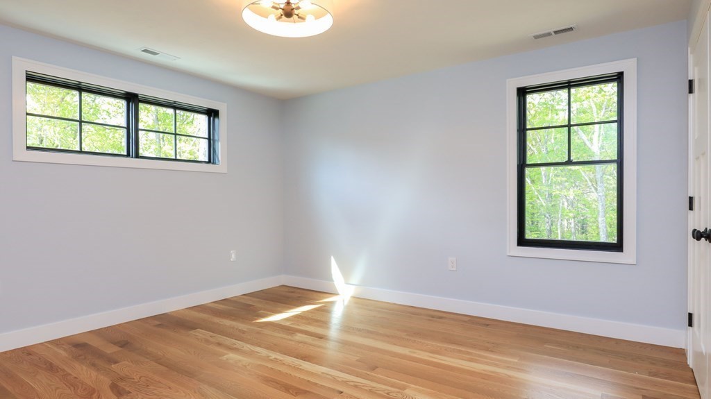 340 Longley Road Groton, MA 01450 - Photo 14 of 20 an empty room with wooden floor and windows
