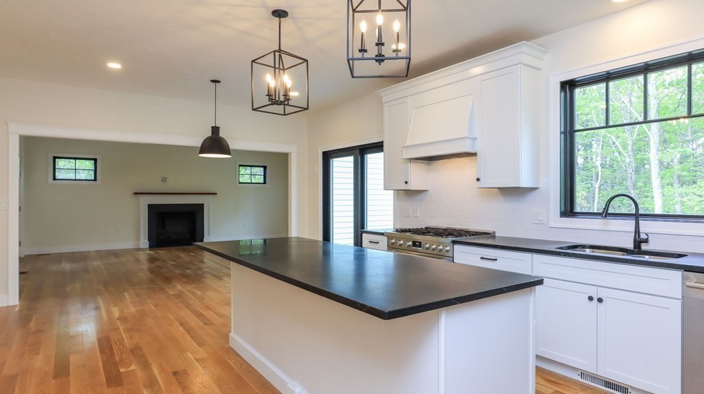 340 Longley Road Groton, MA 01450 - Photo 3 of 20 a kitchen with stainless steel appliances granite countertop a sink a stove and a wooden floors