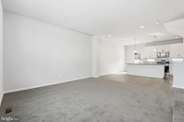 a view of a kitchen with refrigerator and a sink