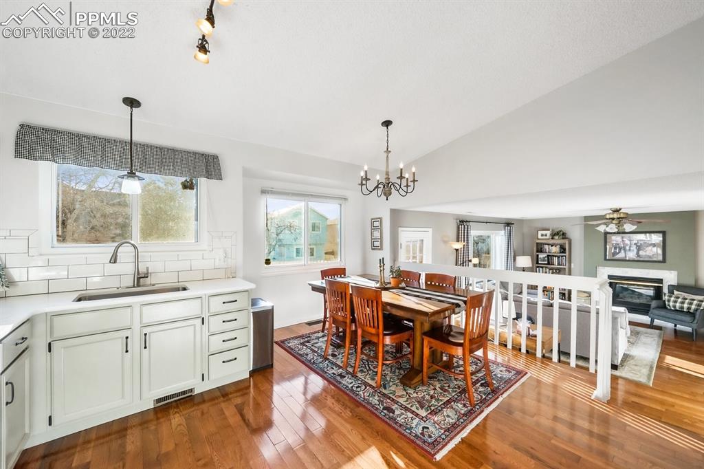 5145 Slickrock Drive Colorado Springs, CO 80923 - Photo 11 of 33 a large kitchen with lots of counter space and chandelier