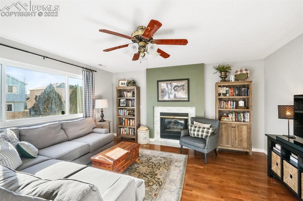 5145 Slickrock Drive Colorado Springs, CO 80923 - Photo 13 of 33 a living room with furniture and a fireplace