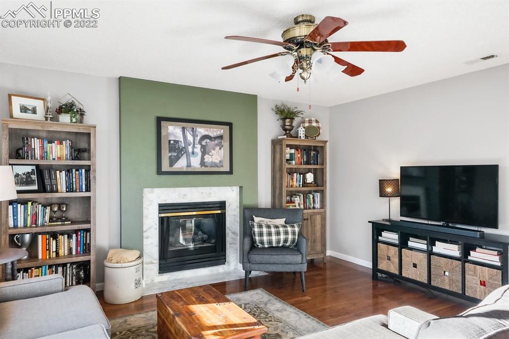 5145 Slickrock Drive Colorado Springs, CO 80923 - Photo 14 of 33 a living room with furniture and a flat screen tv