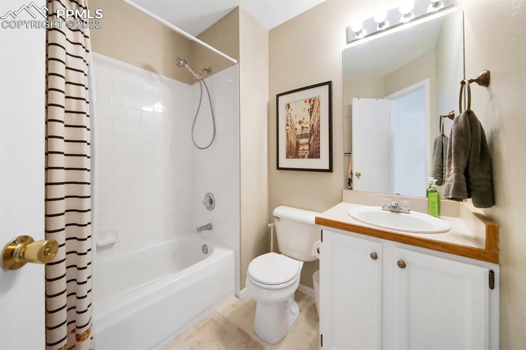5145 Slickrock Drive Colorado Springs, CO 80923 - Photo 17 of 33 a bathroom with a sink vanity mirror and toilet