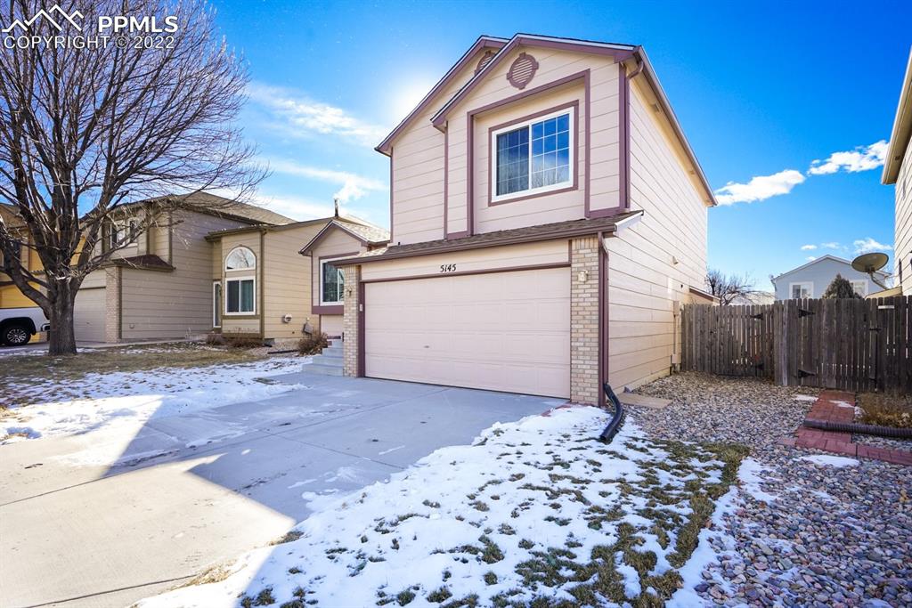5145 Slickrock Drive Colorado Springs, CO 80923 - Photo 2 of 33 a front view of a house with a yard