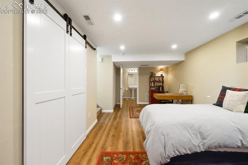 5145 Slickrock Drive Colorado Springs, CO 80923 - Photo 23 of 33 a bed room with a bed and a large mirror