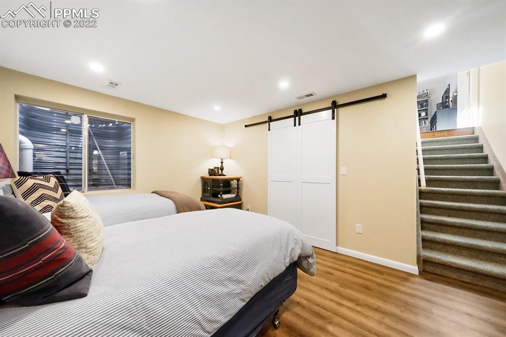 5145 Slickrock Drive Colorado Springs, CO 80923 - Photo 24 of 33 a spacious bedroom with a bed and a window