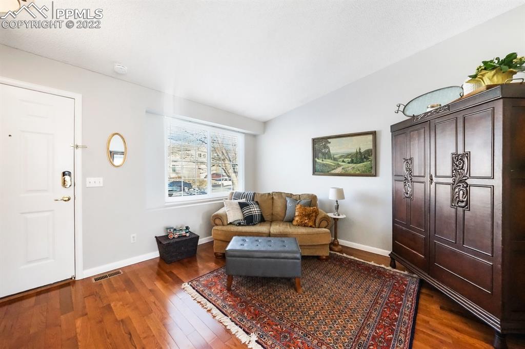 5145 Slickrock Drive Colorado Springs, CO 80923 - Photo 5 of 33 a living room with furniture and a rug