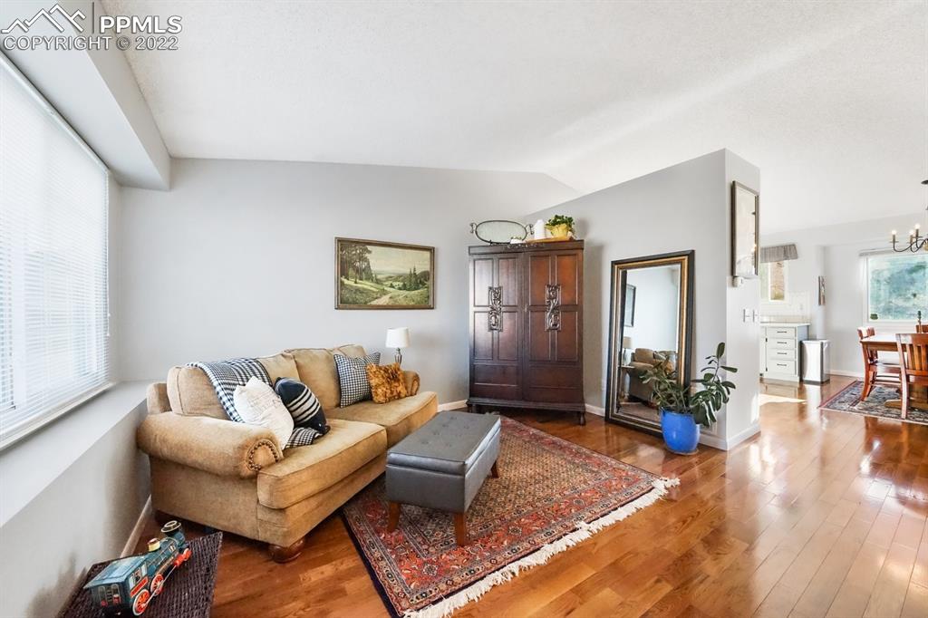 5145 Slickrock Drive Colorado Springs, CO 80923 - Photo 6 of 33 a living room with furniture and wooden floor