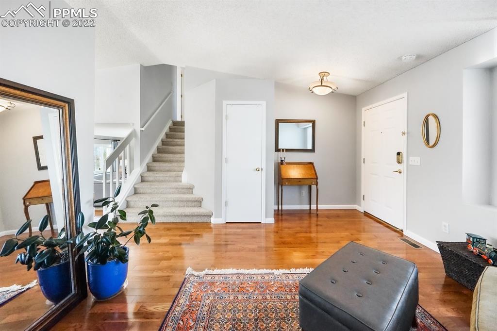 5145 Slickrock Drive Colorado Springs, CO 80923 - Photo 7 of 33 a view of an entryway with wooden floor