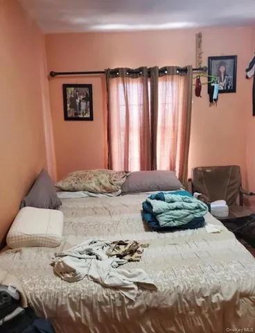 a bedroom with bed and a window