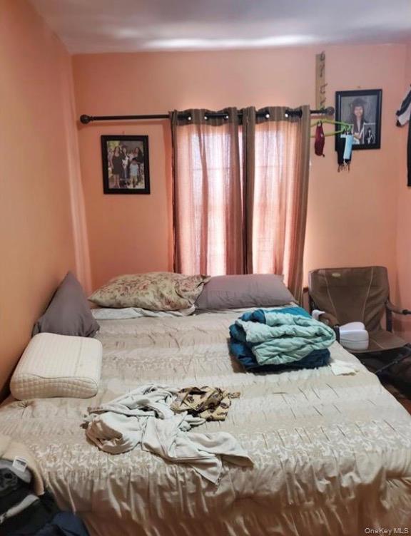 103-55 52nd Avenue Queens, NY 11368 - Photo 11 of 13 a bedroom with bed and a window