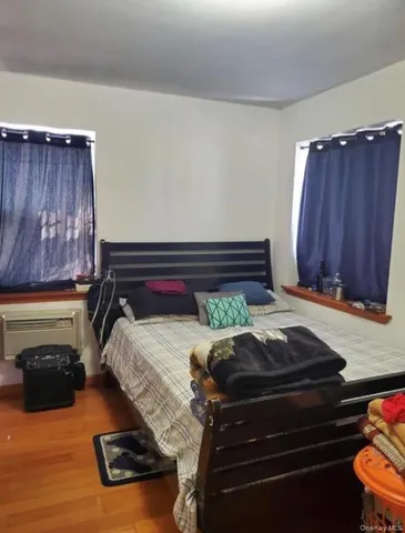 a bed sitting in a room next to a window