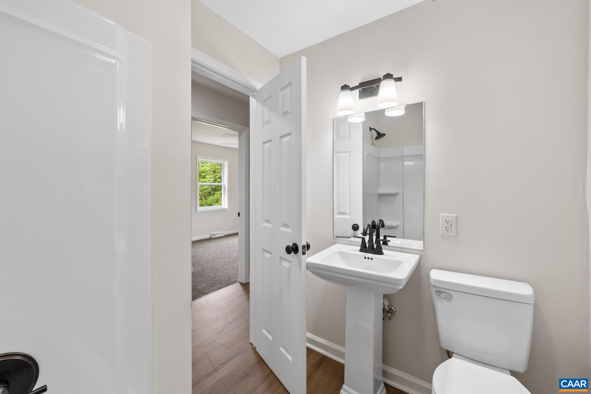 19 Harlow Town Road Louisa, VA 23093 - Photo 20 of 26 a bathroom with a sink toilet and a mirror