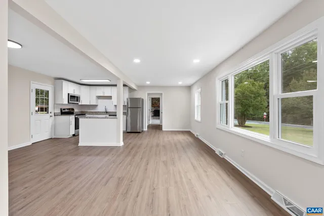 a view of a kitchen with wooden floor