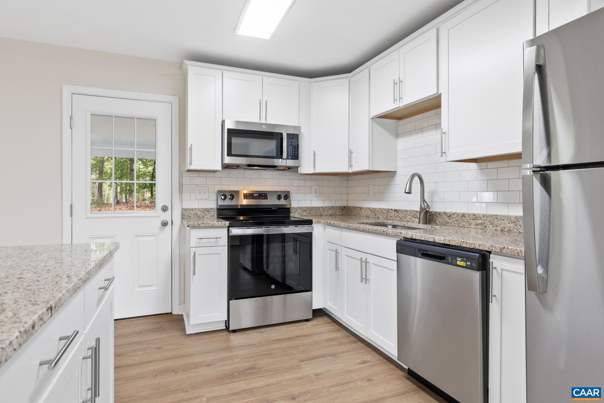 19 Harlow Town Road Louisa, VA 23093 - Photo 8 of 26 a kitchen with stainless steel appliances granite countertop a refrigerator stove microwave and sink