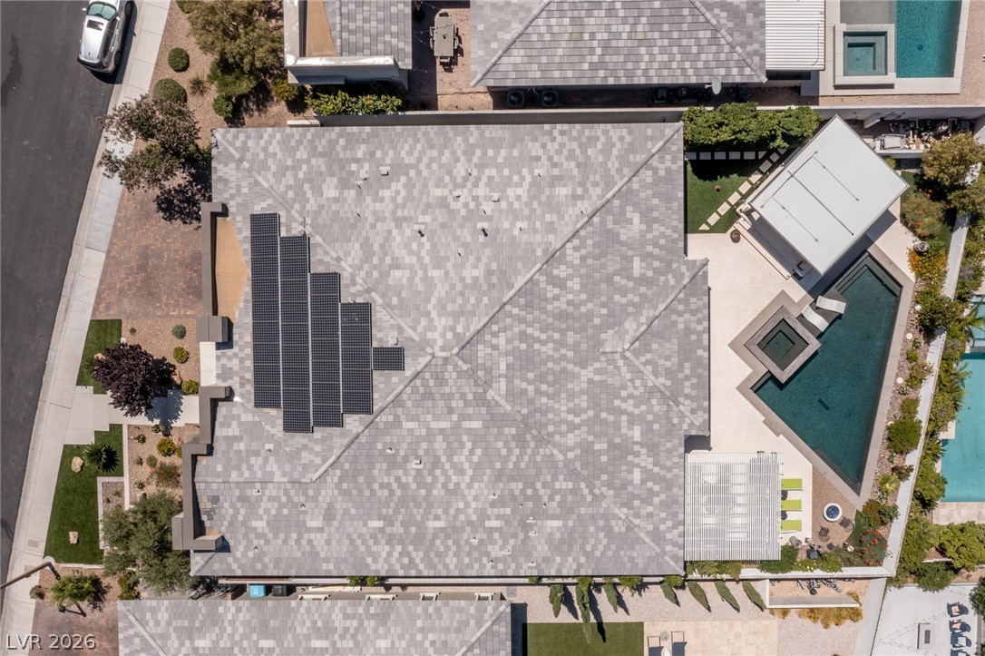 10118 Copper Edge Road Las Vegas, NV 89148 - Photo 47 of 48 An aerial perspective reveals solar panels on the roof and a private pool with an integrated spa, all set within a manicured landscape.