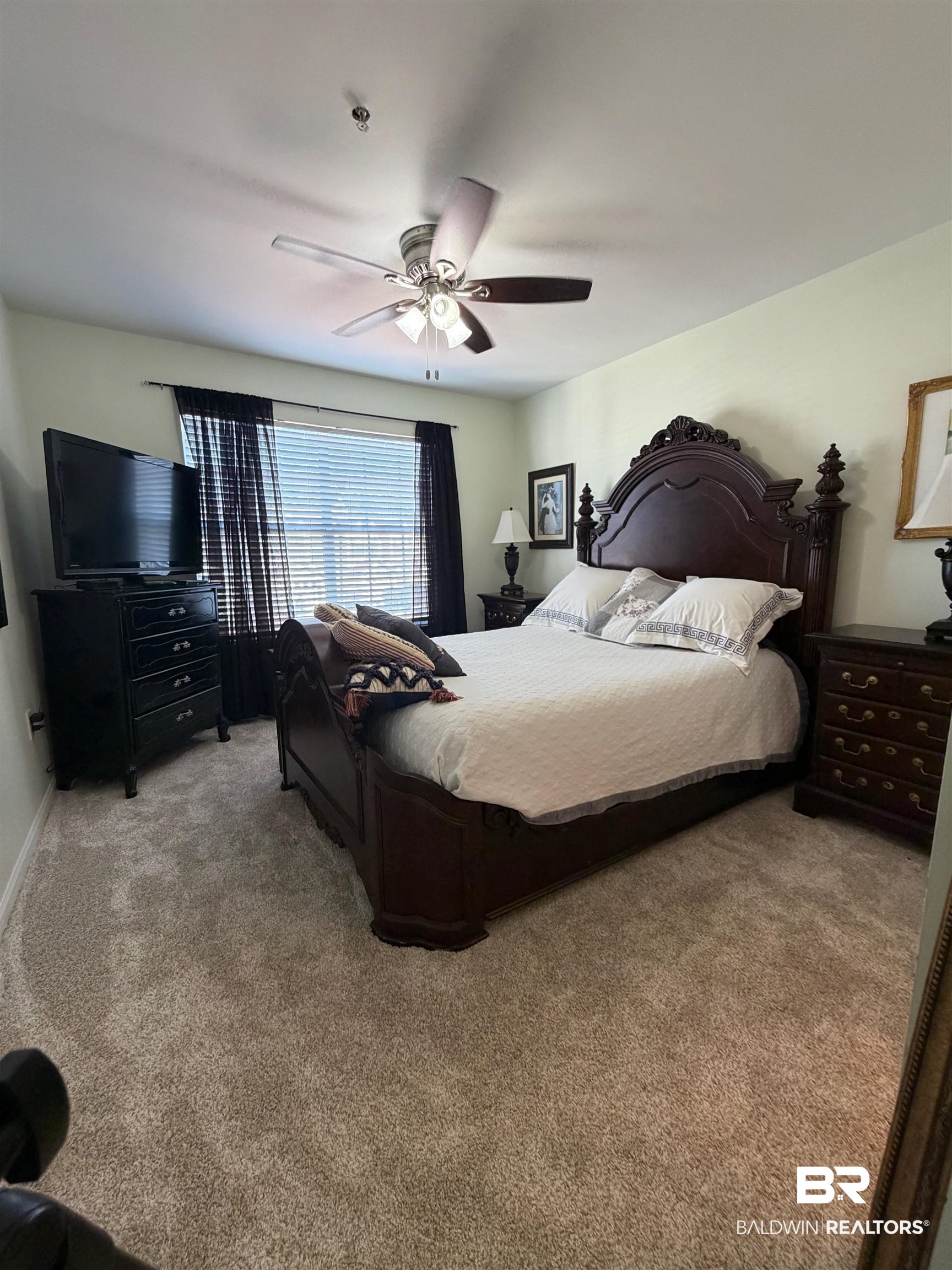 1517 Regency Road, Unit 71 Gulf Shores, AL 36542 - Photo 15 of 26 Bedroom with ceiling fan and light colored carpet