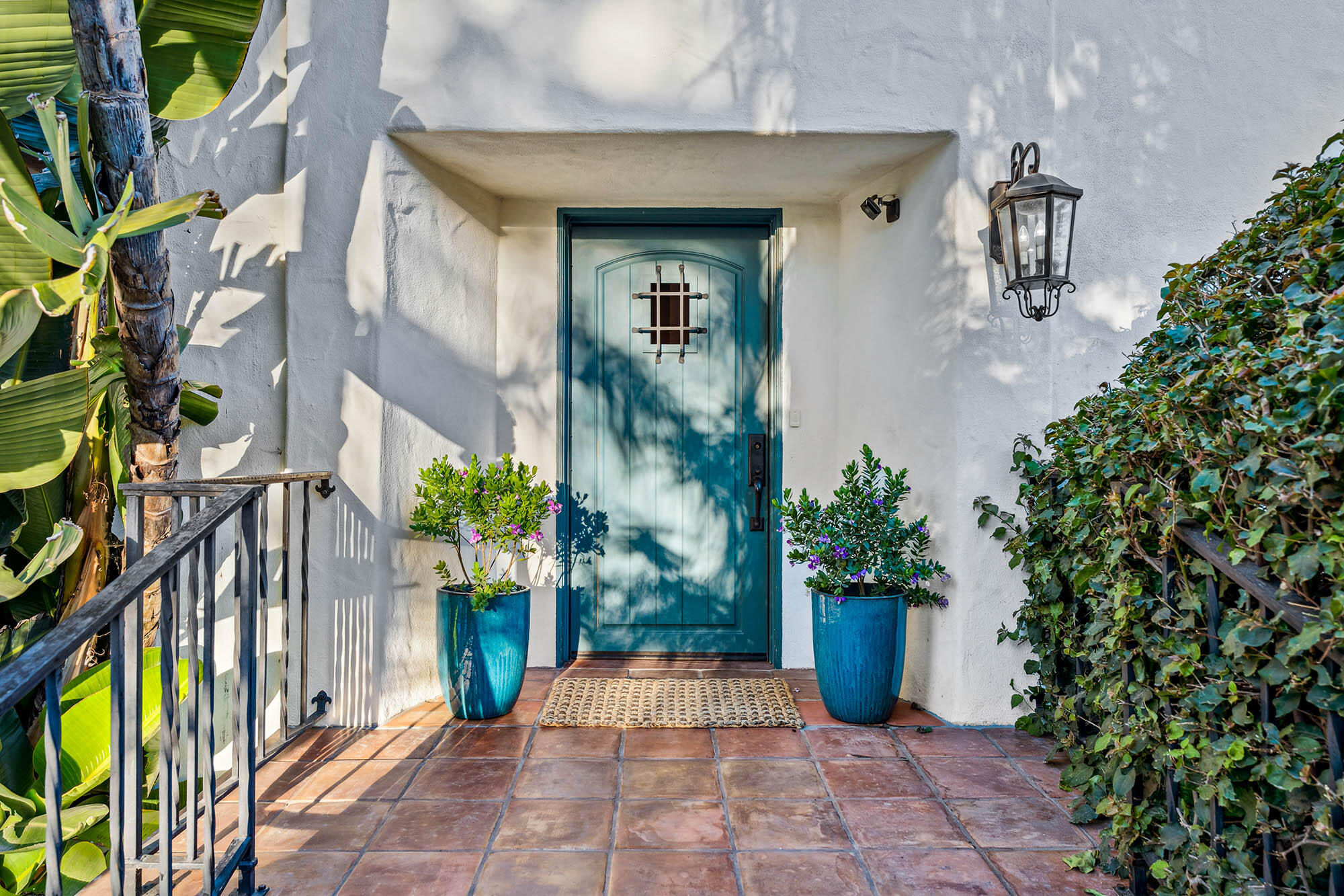 396 Las Alturas Road Santa Barbara, CA 93103 - Photo 14 of 70 a view of a entryway door with potted plants in front of house
