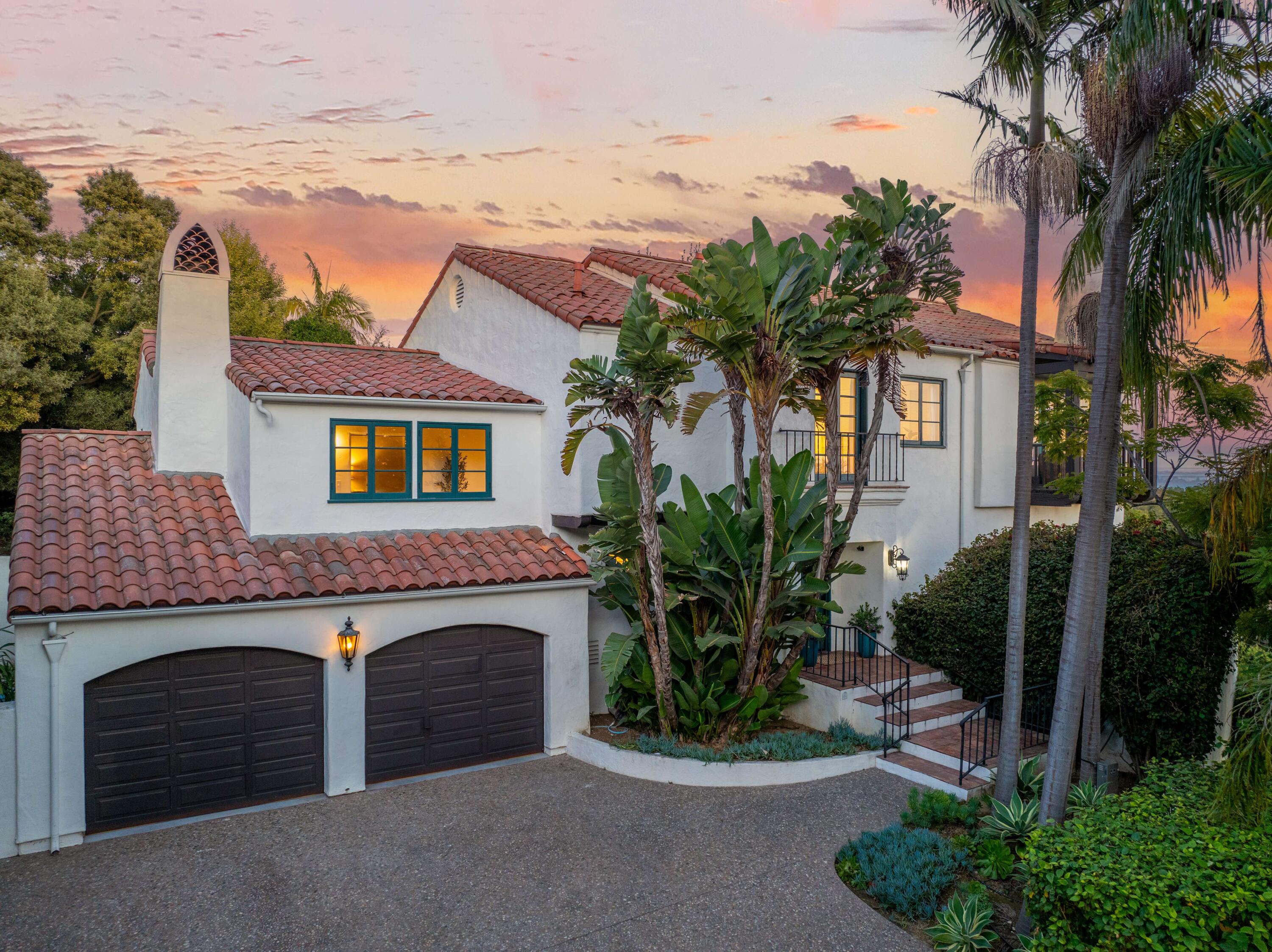 396 Las Alturas Road Santa Barbara, CA 93103 - Photo 2 of 70 a front view of a house with a yard and garage