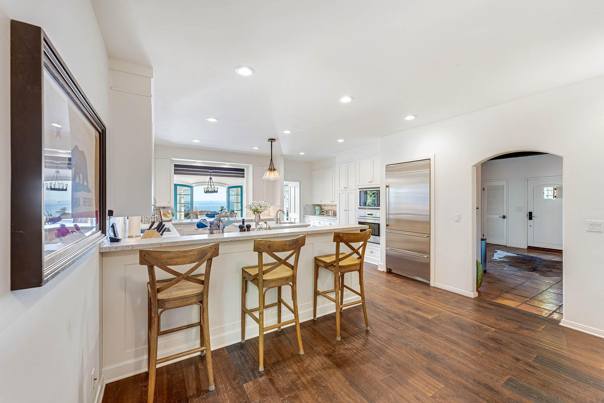 396 Las Alturas Road Santa Barbara, CA 93103 - Photo 23 of 70 a kitchen with stainless steel appliances a dining table chairs and wooden floor