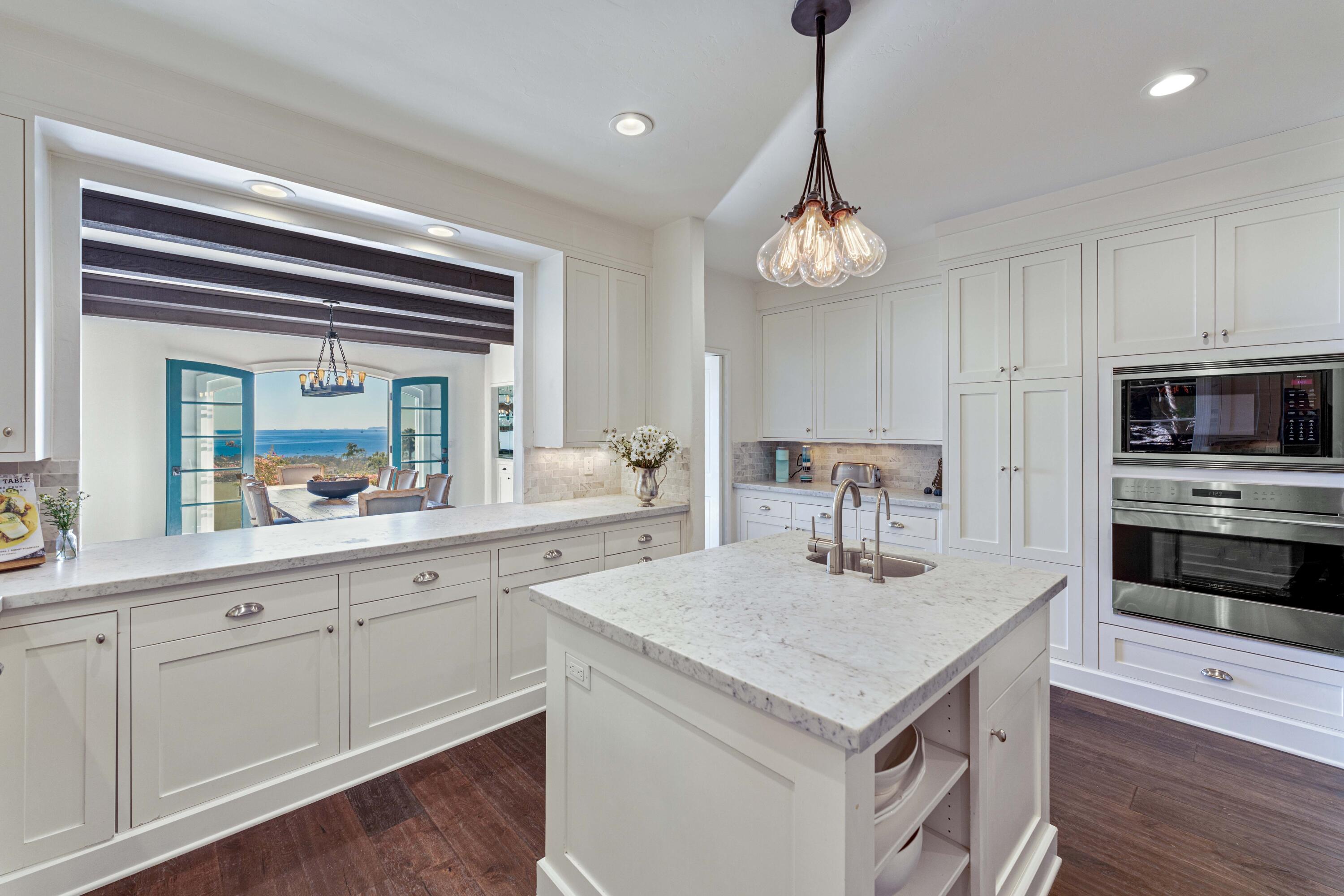 396 Las Alturas Road Santa Barbara, CA 93103 - Photo 25 of 70 a kitchen with a center island appliances and cabinets
