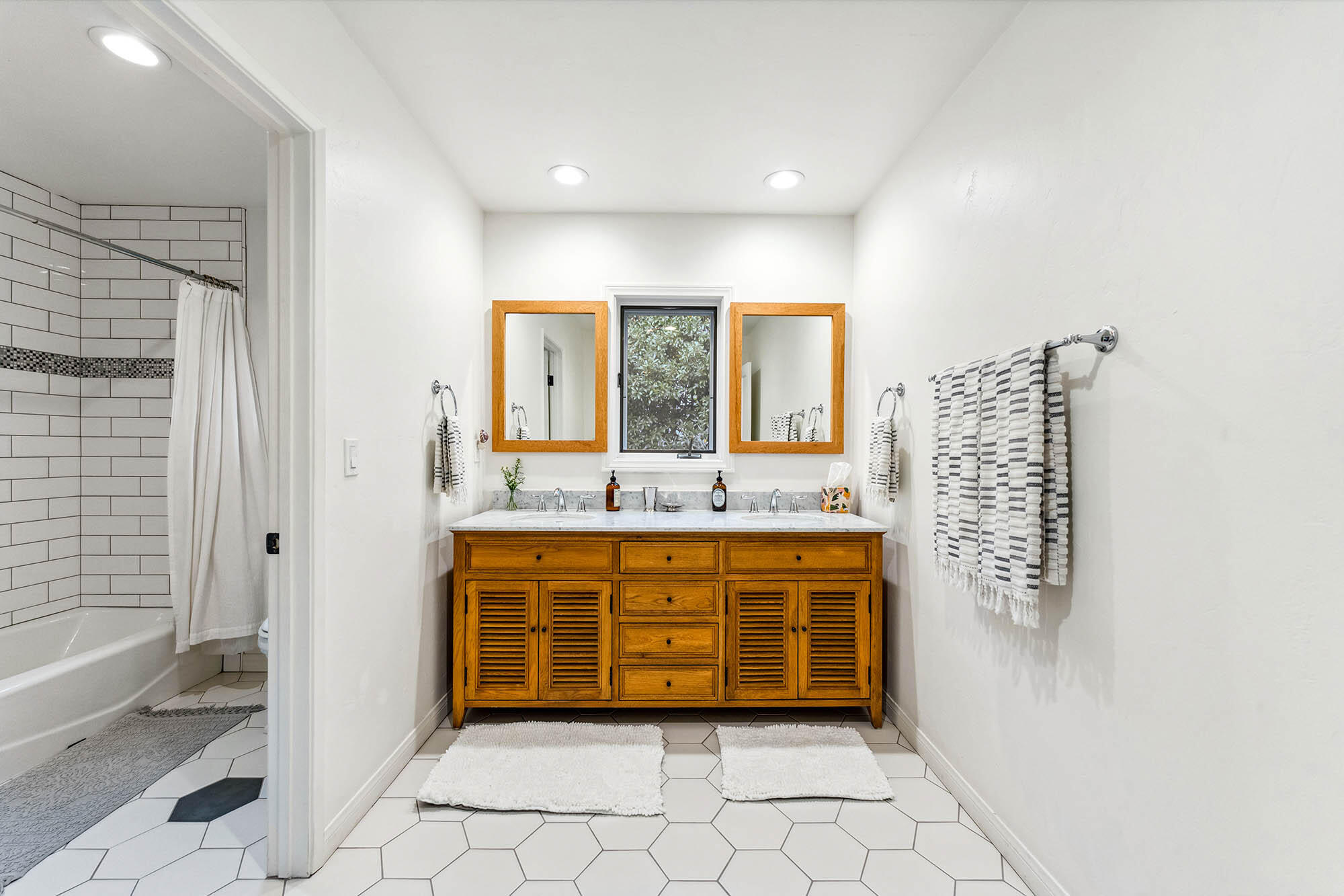 396 Las Alturas Road Santa Barbara, CA 93103 - Photo 34 of 70 a spacious bathroom with a granite countertop sink a mirror and a bathtub