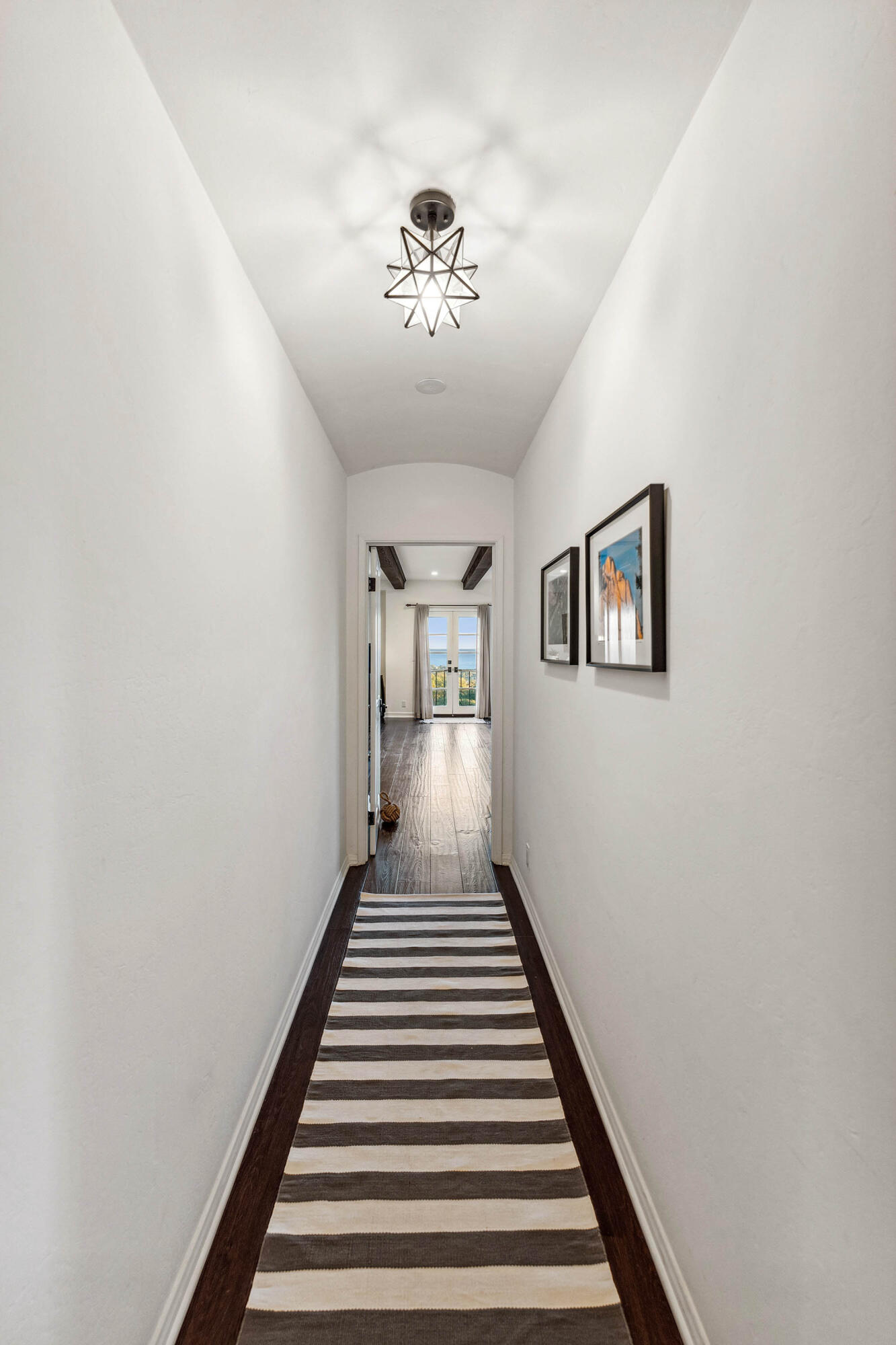 396 Las Alturas Road Santa Barbara, CA 93103 - Photo 38 of 70 a view of a hallway with wooden floor and a chandelier