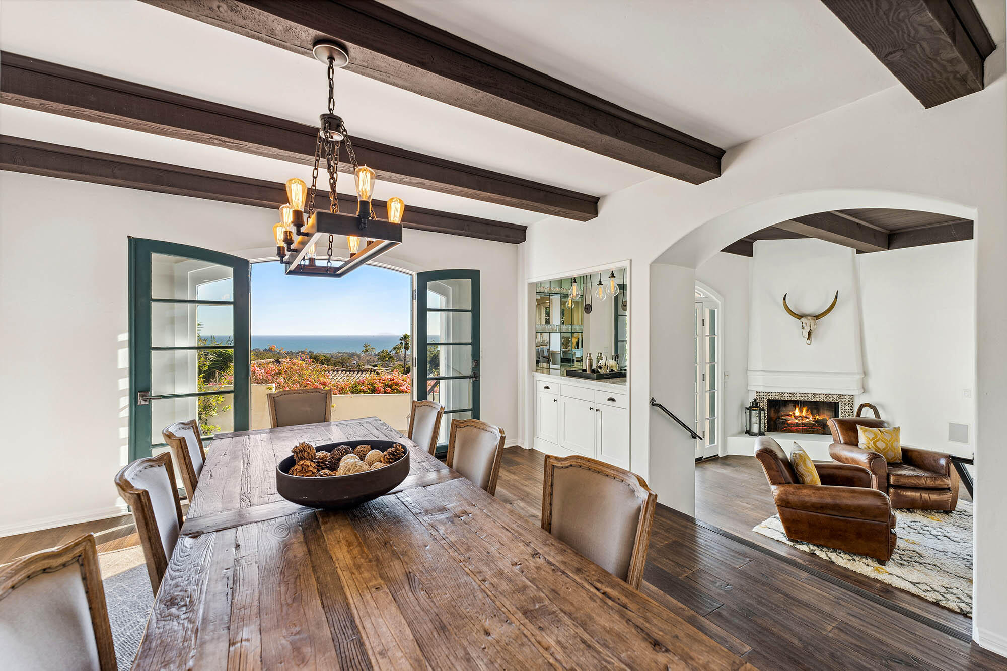 396 Las Alturas Road Santa Barbara, CA 93103 - Photo 4 of 70 a view of a dining room and livingroom with furniture wooden floor a chandelier
