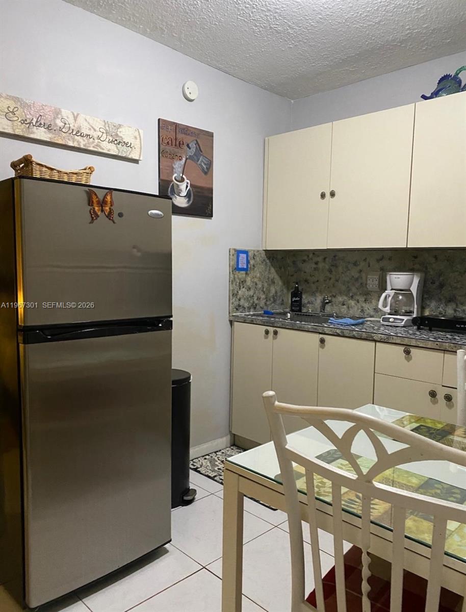 1760 Northeast 144th Street Miami, FL 33181 - Photo 26 of 83 a kitchen with stainless steel appliances granite countertop a refrigerator and a stove