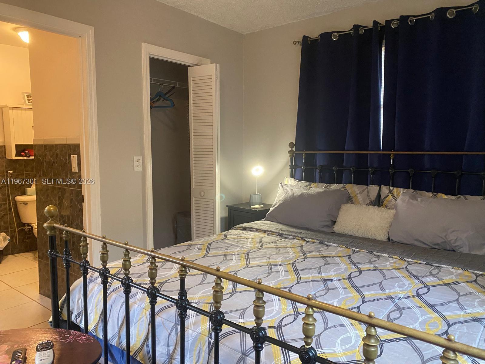 1760 Northeast 144th Street Miami, FL 33181 - Photo 35 of 83 a bedroom with a bed window and a potted plant