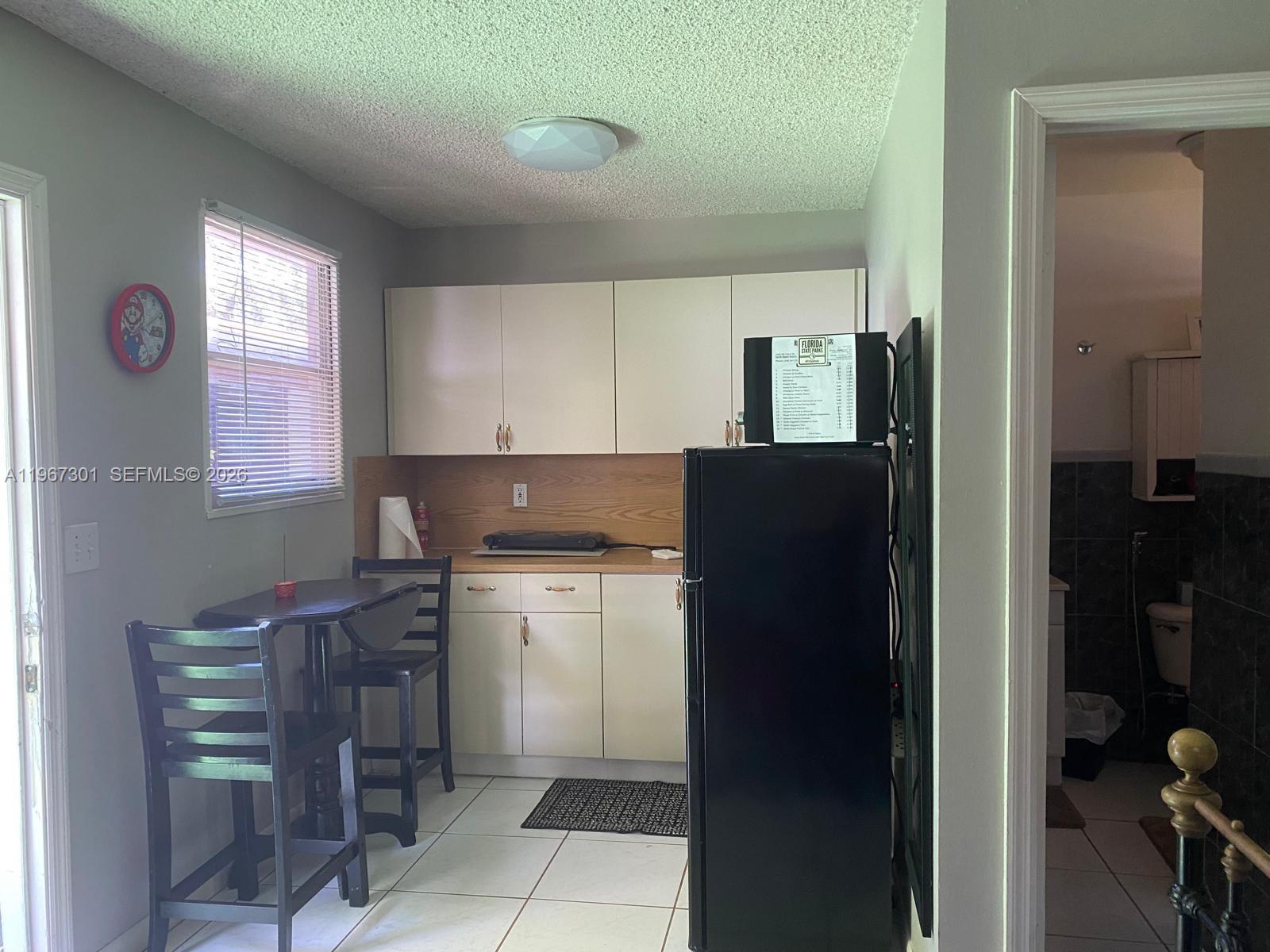 1760 Northeast 144th Street Miami, FL 33181 - Photo 38 of 83 a kitchen with a refrigerator and a stove top oven