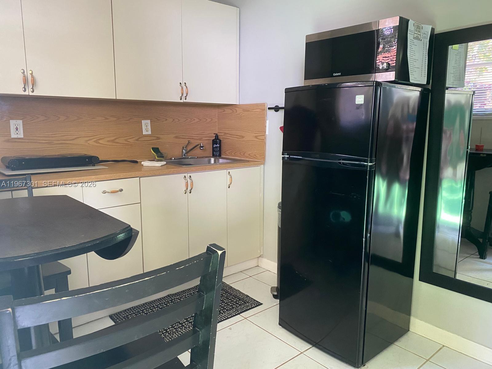 1760 Northeast 144th Street Miami, FL 33181 - Photo 39 of 83 a kitchen with stainless steel appliances a refrigerator and a sink