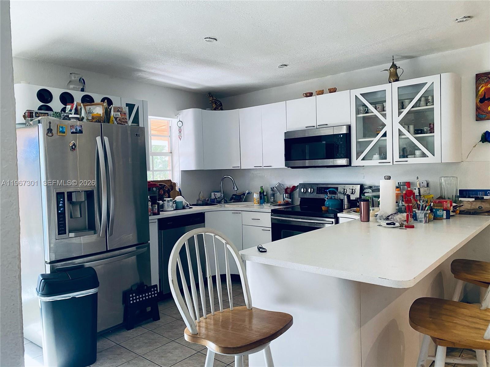 1760 Northeast 144th Street Miami, FL 33181 - Photo 43 of 83 a kitchen with granite countertop a refrigerator stove and sink