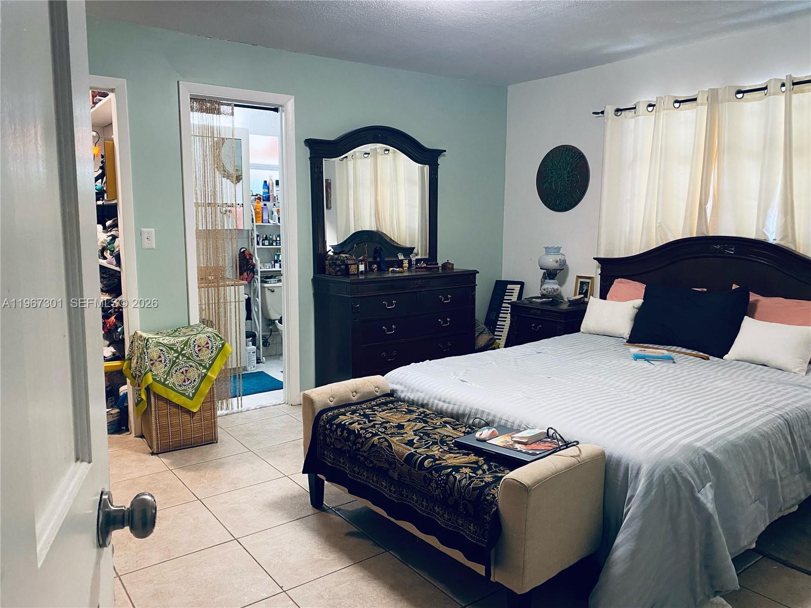 1760 Northeast 144th Street Miami, FL 33181 - Photo 57 of 83 a bedroom with a bed mirror and window