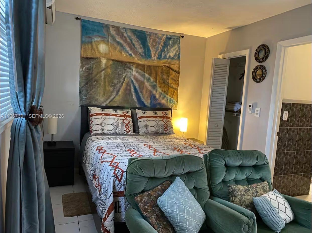 1760 Northeast 144th Street Miami, FL 33181 - Photo 62 of 83 a bedroom with a bed and a window