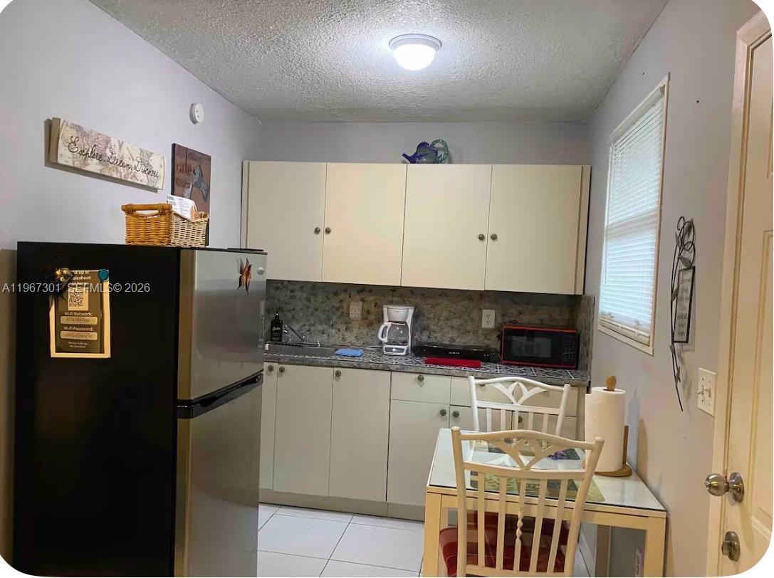 1760 Northeast 144th Street Miami, FL 33181 - Photo 64 of 83 a kitchen with stainless steel appliances a refrigerator and a stove top oven