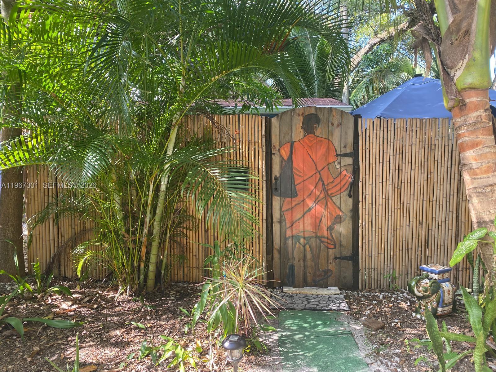 1760 Northeast 144th Street Miami, FL 33181 - Photo 71 of 83 a backyard of a house with lots of green space and fountain