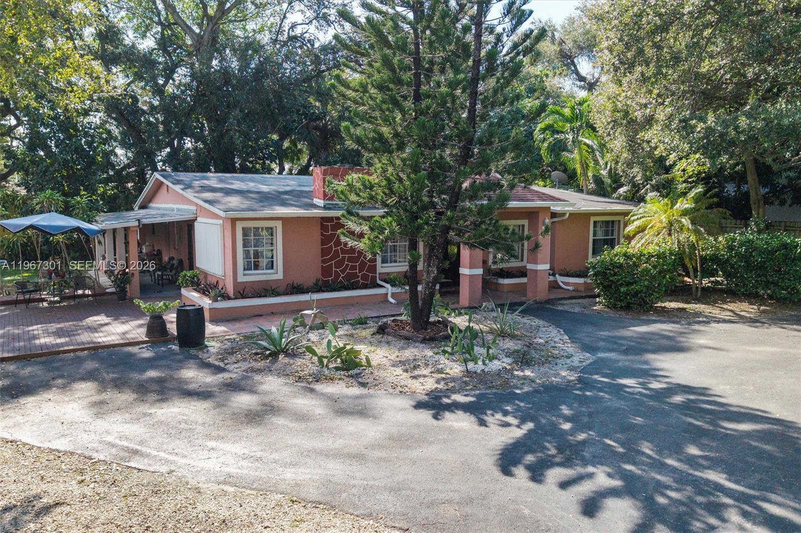 1760 Northeast 144th Street Miami, FL 33181 - Photo 8 of 83 a white house that has a tree in front of it