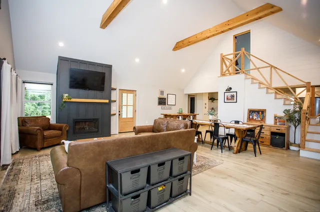 a living room with furniture fireplace and a flat screen tv
