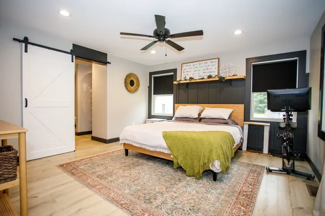 a bedroom with a bed and a flat screen tv