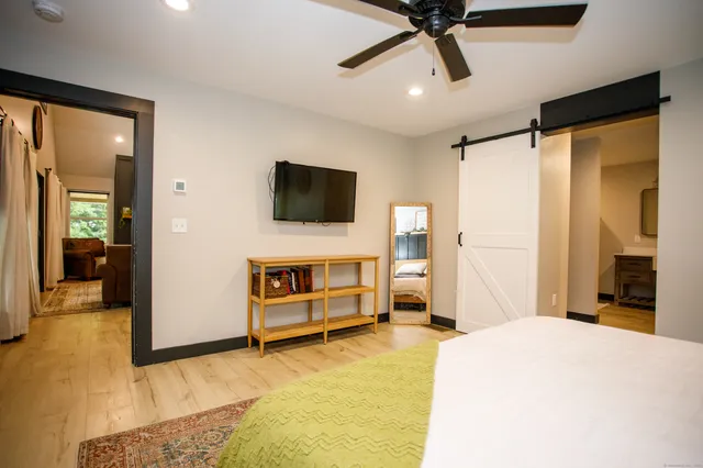 a bedroom with a bed and a television