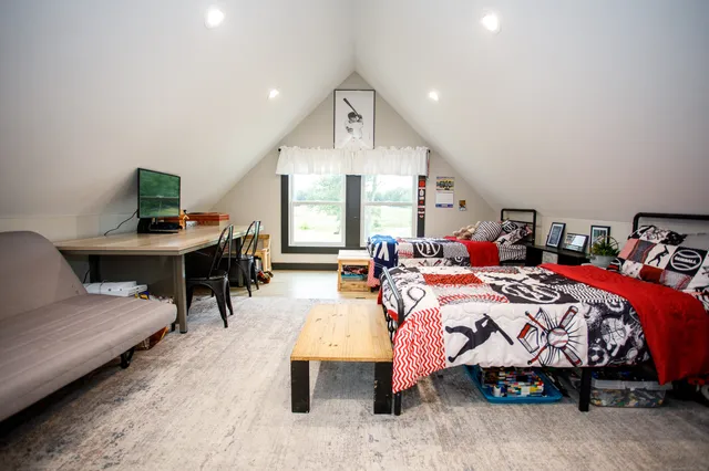 a bedroom with bed and a large window