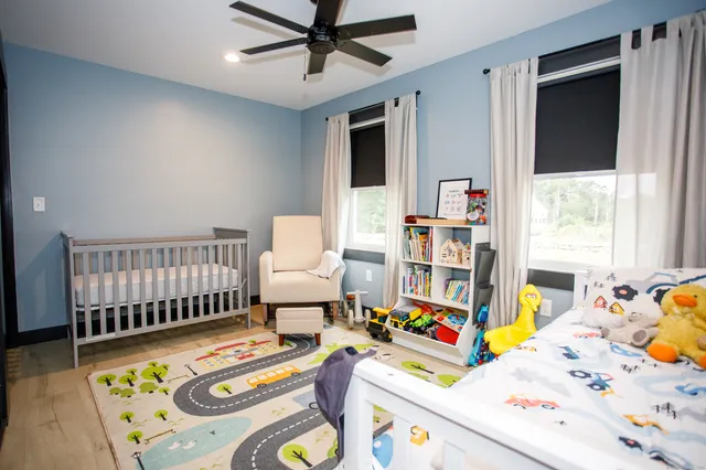 a bedroom with furniture and a wooden floor