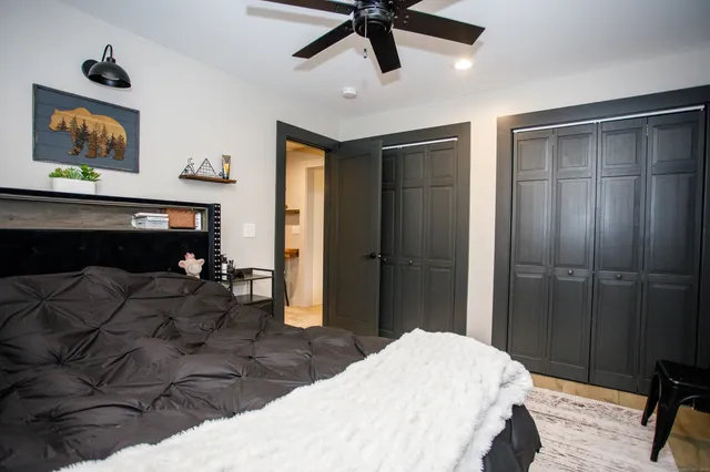 a bedroom with a bed and a painting on the wall