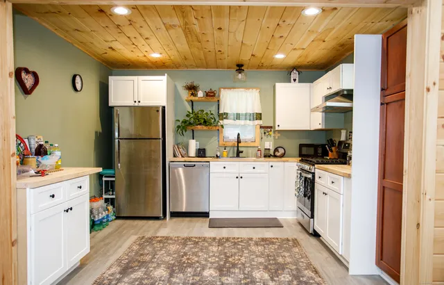 a kitchen with a refrigerator and a stove