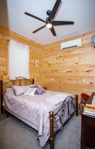 a bedroom with a bed and a ceiling fan