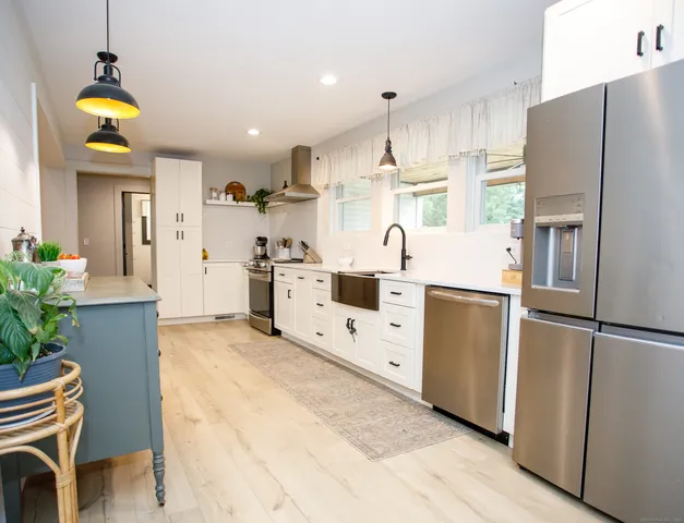 a kitchen with cabinets and wooden flooring