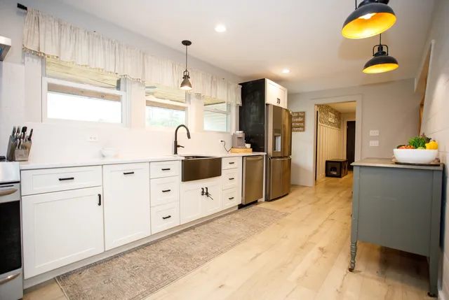 a kitchen with cabinets and window