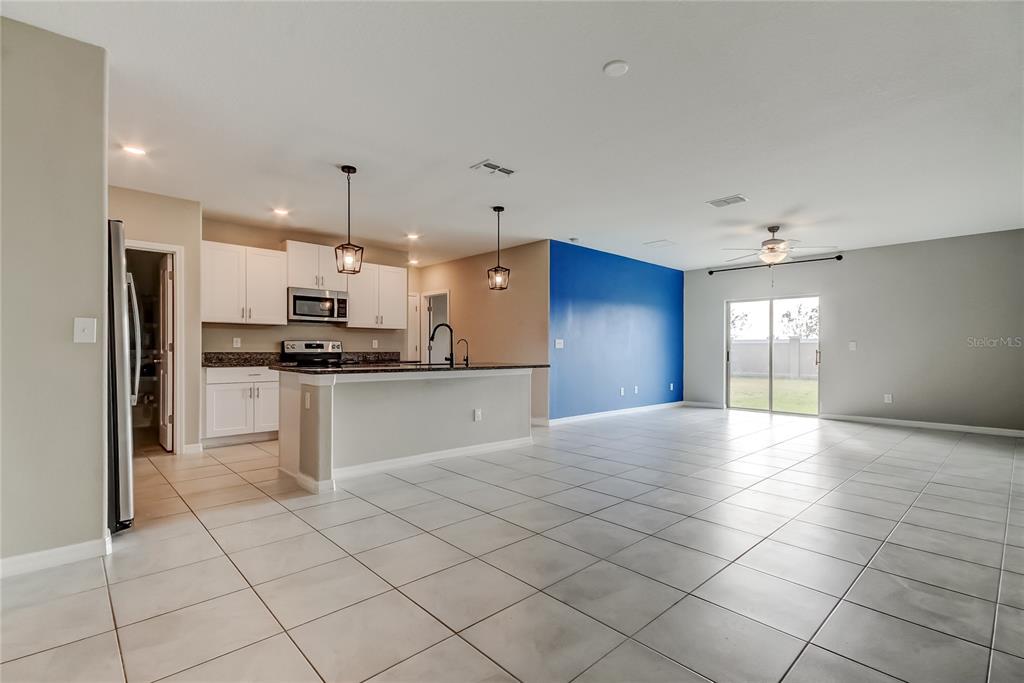 31592 Barrel Wave Way Wesley Chapel, FL 33545 - Photo 18 of 62 a view of kitchen with refrigerator and window